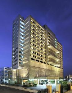 a tall building with lights on in front of it at Holiday Inn New Delhi Mayur Vihar Noida by IHG in New Delhi