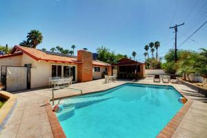 a swimming pool in front of a house at Las Vegas Elegance! Pool Table & Sparkling Pool! Home in Las Vegas