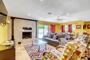 a living room with a couch and a fireplace at Las Vegas Elegance! Pool Table & Sparkling Pool! Home in Las Vegas