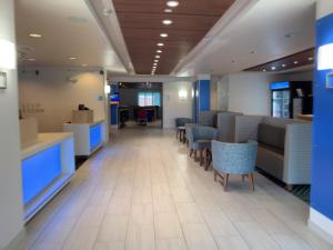 a waiting room with chairs and tables in a building at Holiday Inn Express Hotel & Suites Exmore-Eastern Shore, an IHG Hotel in Exmore