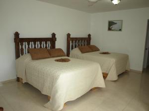 Postel nebo postele na pokoji v ubytování Hotel Rancho Don Cesar