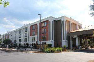 a large white and red building with a parking lot at Holiday Inn Express Forsyth, an IHG Hotel in Forsyth