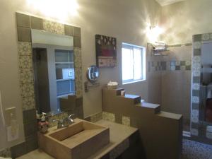 a large bathroom with a sink and a shower at Hotel La Quinta del Sol in Punta Mita