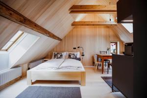 a bedroom with a bed and a dining room at AUGUST Dachgeschosswohnung im jüdischen Viertel in Hohenems