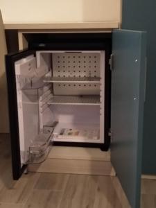 an empty refrigerator with its door open in a kitchen at CASCINA PONTETTO in Asti