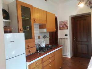 a kitchen with wooden cabinets and a white refrigerator at Antica Tenuta in Balsorano Nuovo