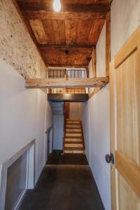 霍恩埃姆斯的住宿－MINA Stadtwohnung im Jüdischen Viertel，走廊设有楼梯和木制天花板