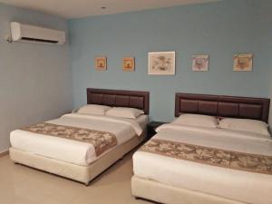 TIONG HUA HOTEL客房内的一张或多张床位