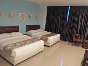 TIONG HUA HOTEL客房内的一张或多张床位