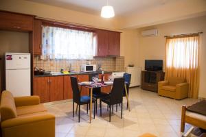 a kitchen with a table and chairs and a kitchen with a kitchen at Zante Xigia Bay villas in Khartáta