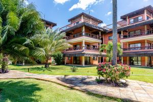 an exterior view of a resort with palm trees at Cumbuco Dream Village Duplex with 3 bedrooms in Cumbuco