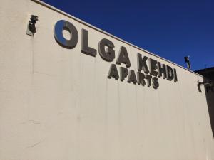 a sign on the side of a white building at Olga Kehdi Residence in Campo Grande