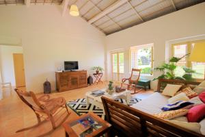 a living room with a couch and a table at Charming villa with swimming pool MQSA20 in Sainte-Anne