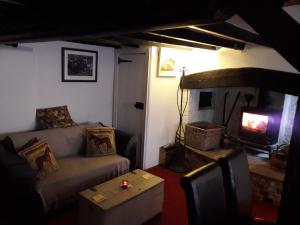 a living room with a couch and a tv at White Horse Inn in Andover