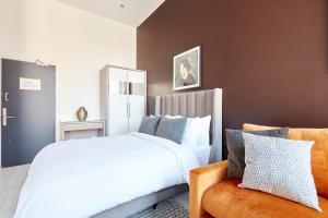 a bedroom with a large bed and a chair at Sonder Mountjoy Square in Dublin