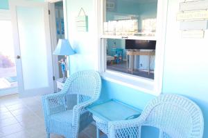 two wicker chairs and a table in a room at Short walk to beach 3 br 2 bath restored 1935 home in Grover Beach