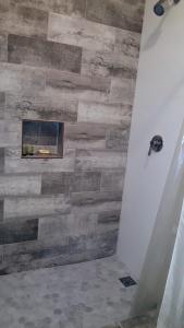 a fireplace in a bathroom with a wooden wall at Latitude Adjustment in San Juan
