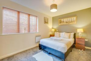 a hotel room with a bed and a window at Mica Point City Centre Apartment in Birmingham