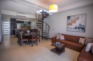 a living room with a couch and a table at San Pedro Hotel, 5ta Avenida in Playa del Carmen
