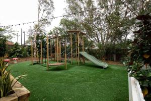 a playground with a slide in a yard at Wentworth Hotel in Sydney
