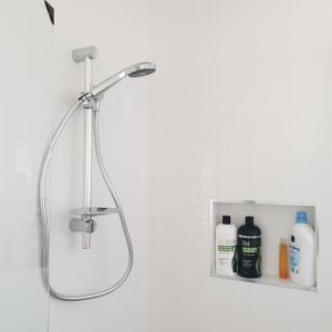 a shower in a bathroom with a shower head at Modern style unit 2 Deer Park in Deer Park