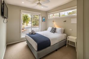 A bed or beds in a room at NRMA Broulee Holiday park