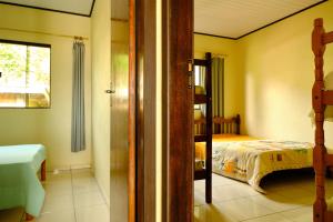 a bedroom with a bed and a bunk bed at Resid.l Canto do Encanto in Garopaba