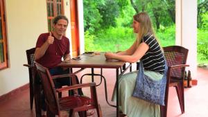 a man and a woman sitting at a table at Punkalasa tourist lodge in Anuradhapura