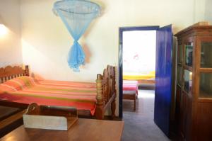 a room with two beds and a door with a window at 15LMD Villa in Front of the Lagoon in Batticaloa