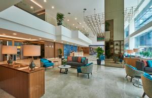 a lobby with couches and chairs in a building at Swiss-Garden Hotel Bukit Bintang Kuala Lumpur in Kuala Lumpur