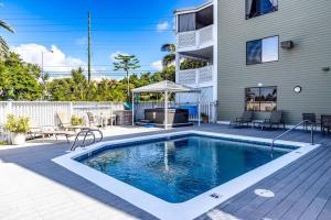 a swimming pool in front of a house at Da Kona West 305 in Kailua-Kona