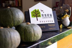 a display of melons on a table with a book at Herbal Life House B&B in Puli
