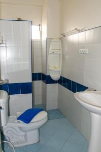 a bathroom with a toilet and a sink at Allstar Guesthouse in Karon Beach