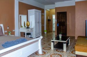 a bedroom with a bed and a dresser and a mirror at Allstar Guesthouse in Karon Beach +65 photos