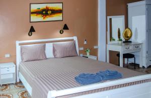 a bedroom with a bed with blue towels on it at Allstar Guesthouse in Karon Beach