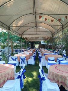 a group of tables and chairs under a large tent at Ban Bang Home Resort in Haad Chao Samran +182 photos