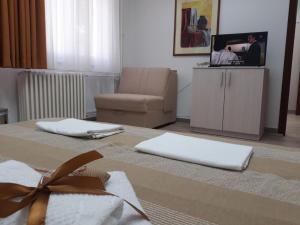 - un salon avec une chaise et une table avec des serviettes dans l'établissement Apartman Karadjordje, à Zvezdara