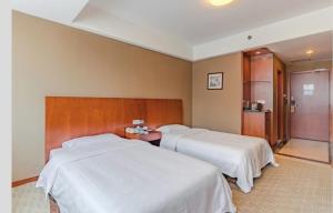 Krevet ili kreveti u jedinici u objektu Huangshan Tiandu International Hotel