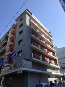 a large building with a large window on top at SUITES@SYNGROU-FIX in Athens