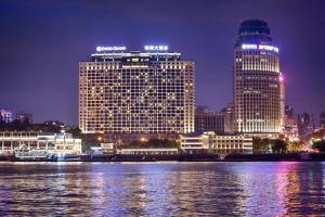 a view of a large building at night at Swiss Grand Xiamen-Harbour View in Xiamen