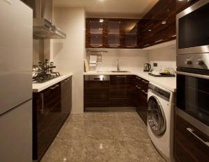 eine Küche mit Waschmaschine und Trockner in der Unterkunft Lee Garden Service Apartment in Peking