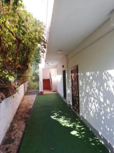 a hallway of a house with a green lawn at Gouvia House Luxury Apartments in Gouvia