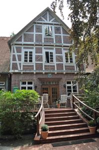 a brick house with stairs in front of it at Ferienhof Heimberg - Bowe GbR in Sauensiek