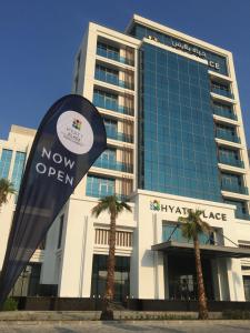 a building with a now open sign in front of it at Hyatt Place Dubai Jumeirah in Dubai