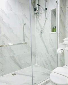 a shower with a glass door in a bathroom at Urban house in Bangkok
