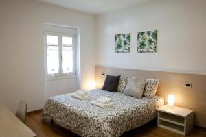 Postel nebo postele na pokoji v ubytování Conte Durini Apartments & Rooms