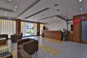 a lobby with chairs and a counter in a hospital at HOTEL HARMONY in Vadodara