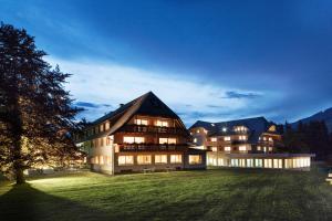a large building with lights on in a field at Hotel Rössle in Bernau im Schwarzwald