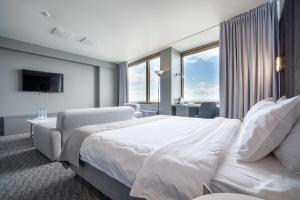 Un pat sau paturi într-o cameră la Astrus Hotel Moscow