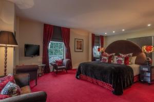 a hotel room with a bed and a tv at Orsett Hall in Orsett